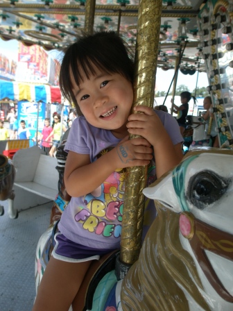 Karis riding the carousel